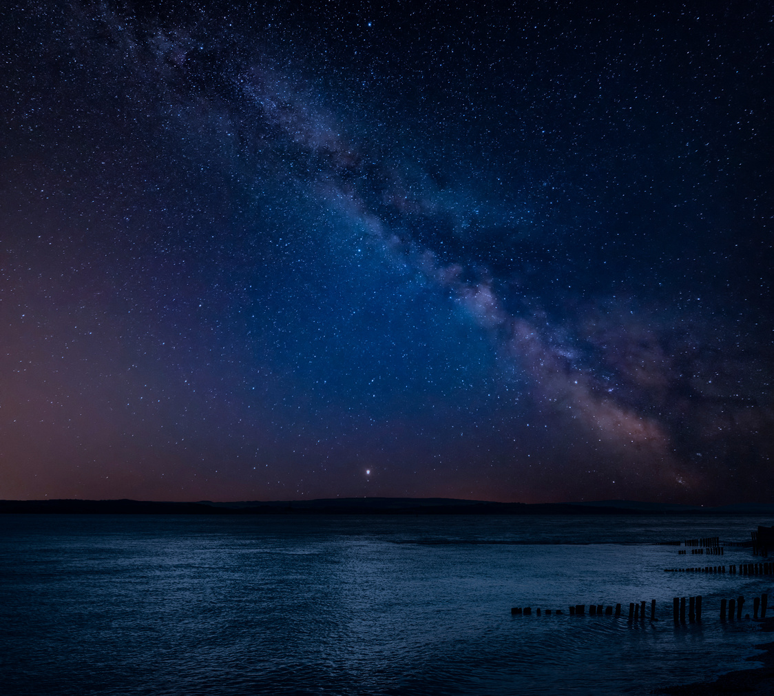 Vibrant Milky Way Composite Image over Landscape of Beautiful Se